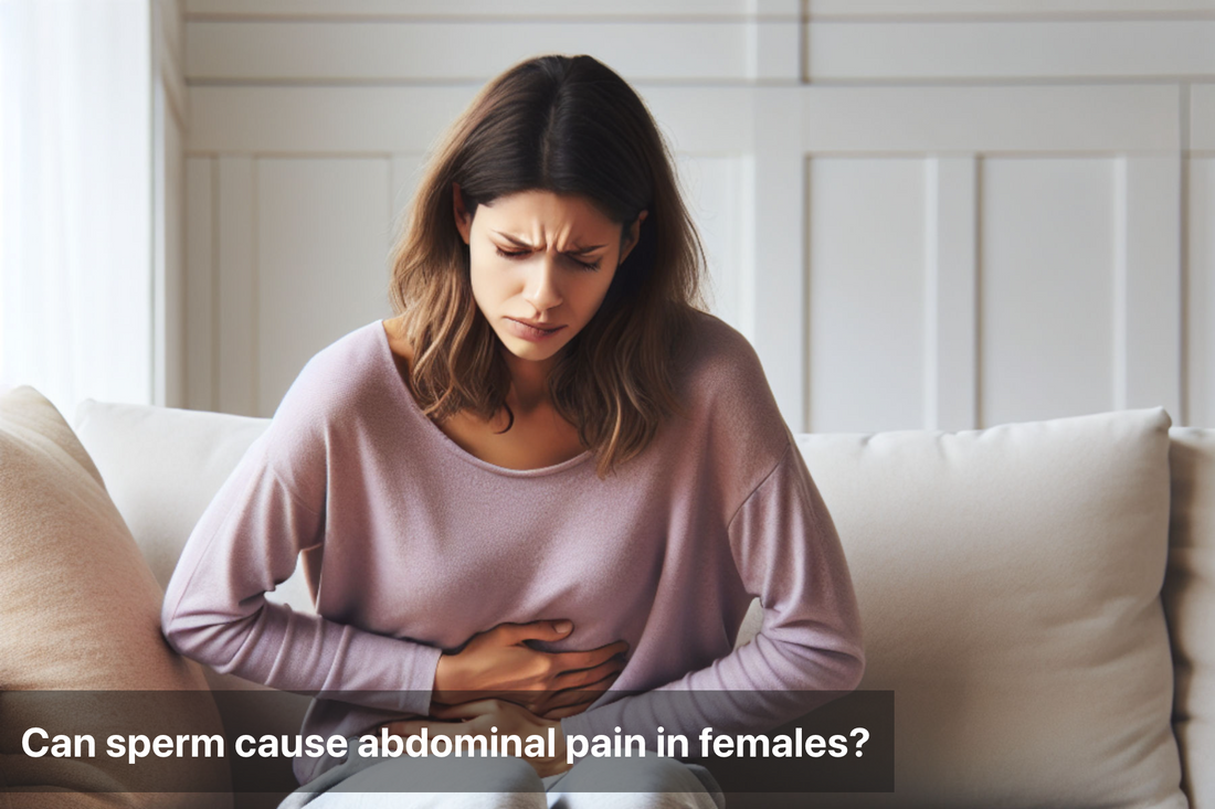 Woman experiencing abdominal pain while sitting on a couch